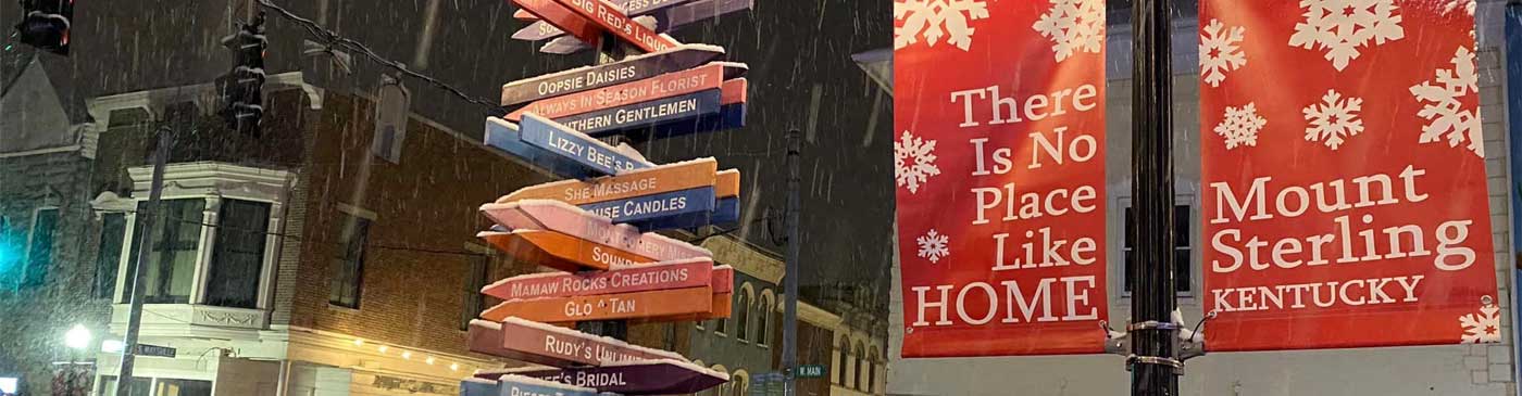 snow falling and "there's no place like home" banner in Mt. Sterling, KY